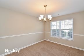 Douglasville house for rent - an empty dining room with a window and a chandelier