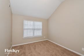 Douglasville house for rent - a bedroom with beige carpet and a window