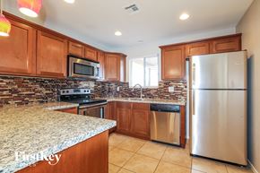 Phoenix house for rent - an updated kitchen with stainless steel appliances and granite counter tops