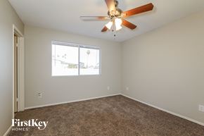 Phoenix house for rent - a bedroom with a ceiling fan and a window