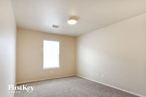 Houston house for rent - a bedroom with white walls and carpet and a window