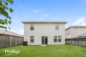Houston house for rent - a white house with a grassy yard and a wooden fence