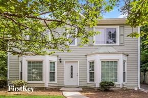 Acworth house for rent - the exterior of a house with white siding and white windows