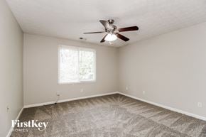 Acworth house for rent - a bedroom with carpet and a ceiling fan