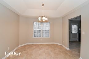 Douglasville house for rent - an empty dining room with a window and a chandelier