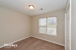 Douglasville house for rent - the spacious bedroom has carpeted floors and a large window