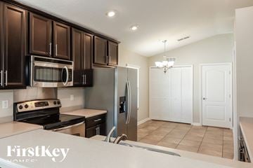 Middleburg house for rent - A kitchen with dark brown cabinets and stainless steel appliances.