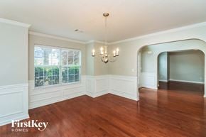 Powder Springs house for rent - an empty dining room with a large window and a chandelier