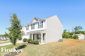 Winston-Salem house for rent - a white house with a yard and a blue sky