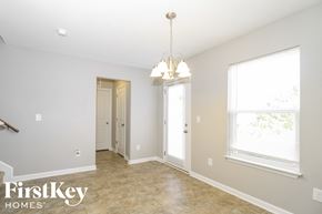 Winston-Salem house for rent - a dining room with a door to a hallway and a chandelier