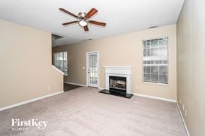 Union City house for rent - a living room with a fireplace and a ceiling fan
