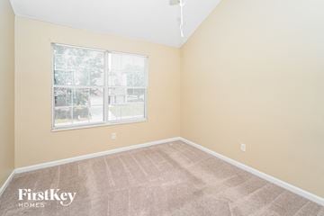 Union City house for rent - the living room of a home with a large window and carpet