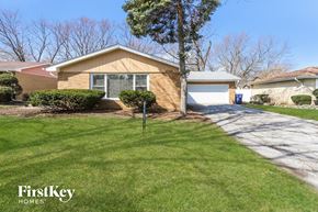 Matteson house for rent - A house with a brown roof and a garage door is shown.