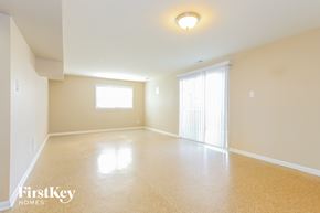 Matteson house for rent - A spacious room with a window and a sliding door.