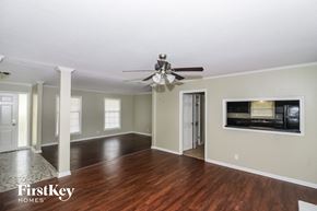 Memphis house for rent - a living room with wood floors and a ceiling fan