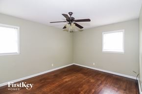 Memphis house for rent - a bedroom with wood flooring and a ceiling fan