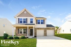 Pfafftown house for rent - A house with a garage and a driveway is shown with the words "FirstKey Homes" on the bottom.