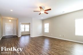 Pfafftown house for rent - A spacious room with wood flooring and a ceiling fan.