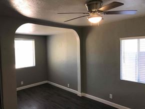 Phoenix house for rent - an empty room with a ceiling fan and a window
