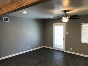 Phoenix house for rent - a living room with gray walls and a ceiling fan