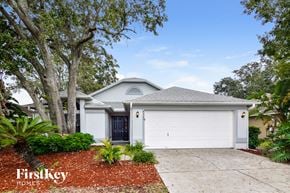 Plant City house for rent - a white house with a driveway and a garage door
