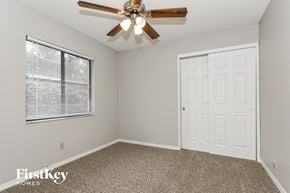 Plant City house for rent - the upstairs bedroom has a ceiling fan and a window