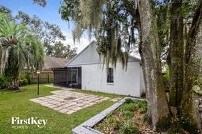 Plant City house for rent - a small white house with a yard and trees