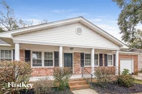 North Charleston house for rent - A house with a white front porch and a brick wall.