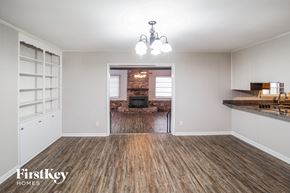 North Charleston house for rent - A room with wooden floors and a chandelier.