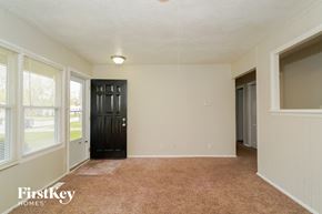 Indianapolis house for rent - the living room of an empty house with a black door