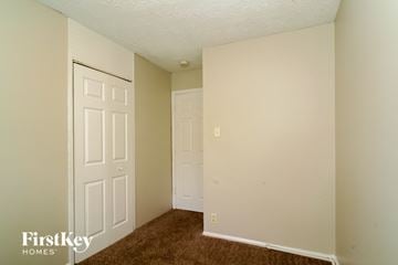 Indianapolis house for rent - a bedroom with two closets and a door and a carpet