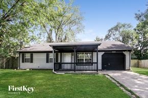 Indianapolis house for rent - A house with a garage and a porch is for sale.