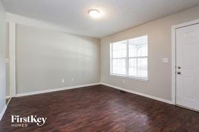 Indianapolis house for rent - A room with wooden floors and a window letting in light.