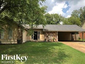 Memphis house for rent - a house with a lawn and a stone wall