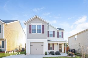 Winston-Salem house for rent - two story house with white and red shutters on a sunny day