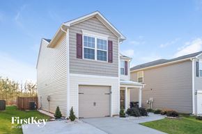 Winston-Salem house for rent - a white and tan house with a garage door