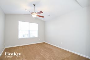 Winston-Salem house for rent - a bedroom with a ceiling fan and a window