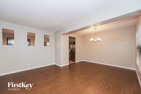 Melbourne house for rent - an empty living room with wood flooring and white walls