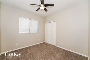 Melbourne house for rent - a bedroom with a ceiling fan and a window