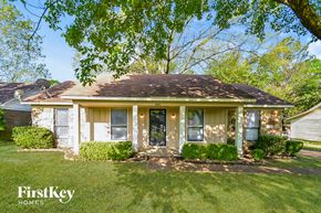 Memphis house for rent - a small white house with a lawn and trees