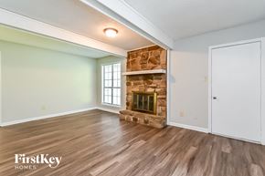 Memphis house for rent - a living room with a fireplace and wooden floors