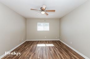 Cape Coral house for rent - the spacious living room with hardwood flooring and a ceiling fan