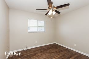 Cape Coral house for rent - a bedroom with a ceiling fan and a window
