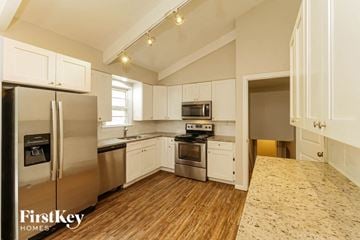 Kansas City house for rent - a kitchen with stainless steel appliances and white cabinets