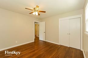 Kansas City house for rent - a bedroom with wood flooring and a ceiling fan