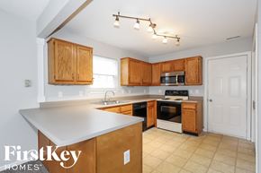Indianapolis house for rent - a kitchen with wooden cabinets and a white counter top