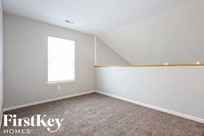 Indianapolis house for rent - a bedroom with a carpeted floor and a window