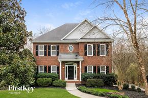 Winston-Salem house for rent - a red brick home with white shutters and a black door