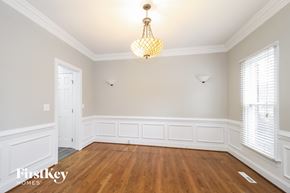 Winston-Salem house for rent - a dining room with white wainscoting and a chandelier