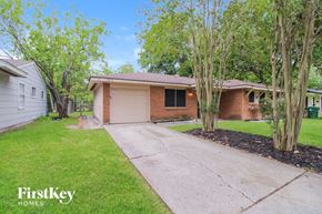 Houston house for rent - a small brick house with a driveway in front of it